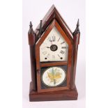 A late 19th Century American mahogany cased mantel clock with leaf decorated door, 21 1/2" high