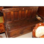An antique oak settle with five back box seat, on stile supports, dated 1721, 65" wide