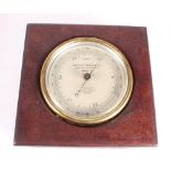 An aneroid barometer by T Wheeler London, in polished as mahogany case