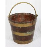 A 19th Century oak and brass bound circular peat bucket with brass swing handle, 13" high