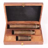 A set of three brass telescopes, in wooden case, 8", 5" and 3" long