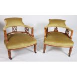 A pair of Victorian carved walnut splat back tub shape elbow chairs, upholstered in an old gold