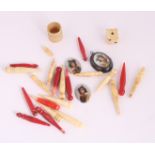 A collection of bone cribbage pegs, a die and three ceramic miniature portraits