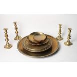 Two pairs of brass candlesticks and a number of brass trays