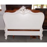 A French design white double bed head with scroll pierced surmount