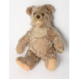 An early 20th Century Steiff gold plush teddy bear with open mouth and growler, 12" high