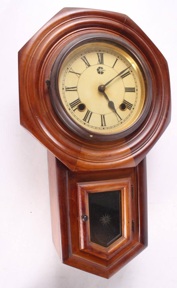 A mahogany cased drop dial wall clock with striking movement