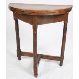 An 18th Century fruitwood semicircular fold-over top occasional table, on three turned and