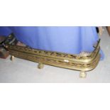 A Victorian brass fender pierced two horizontal bands of leaves, 43" wide