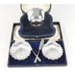 A pair of silver shell-shaped butter dishes and knives, in fitted case, and a christening bowl, in