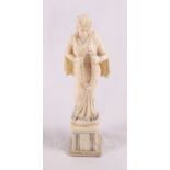 A 19th Century Indian carved ivory figure of a woman holding a wreath of flowers on square bone