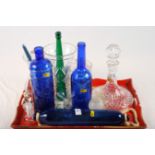 A cut glass ship's decanter, one other decanter, two cut glass vases, a blue glass rolling pin and