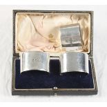 A pair of silver napkin rings, in fitted case, and another to match, 6.1oz troy approx