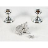 A pair of squat silver candlesticks and two filled silver models of cats