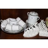 A French porcelain coffee set decorated silver edges, three white toast racks and a Chelsea