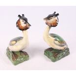 A pair of Royal Doulton china models of Great crested grebes, 12" high (one beak damaged)