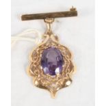 A yellow metal pendant brooch set amethyst coloured stone, frame stamped 18K