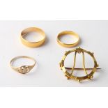 Two 22ct gold wedding bands, 4.6g, an 18ct gold coin brooch mount, 4.3g, and a child's 9ct gold