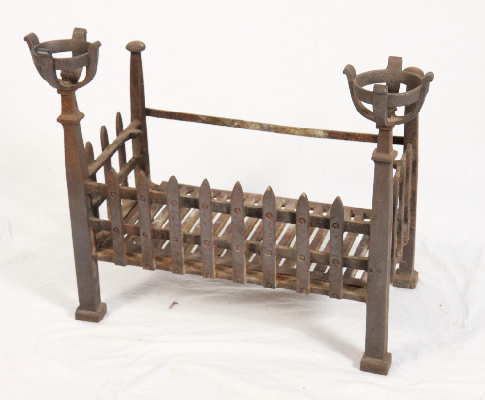 A wrought iron fire grate with cup/cresset terminals, 24" wide