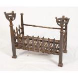 A wrought iron fire grate with cup/cresset terminals, 24" wide