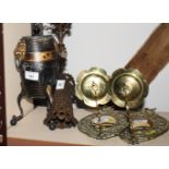 A pair of decorative brass candle wall sconces with oval pierced back plates and winged cherub