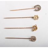 Three gold stick pins set seed pearls and one other with horseshoe design