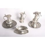 Three pewter tappit hens with acorn finials, a double-ended pewter sauce boat and other items of