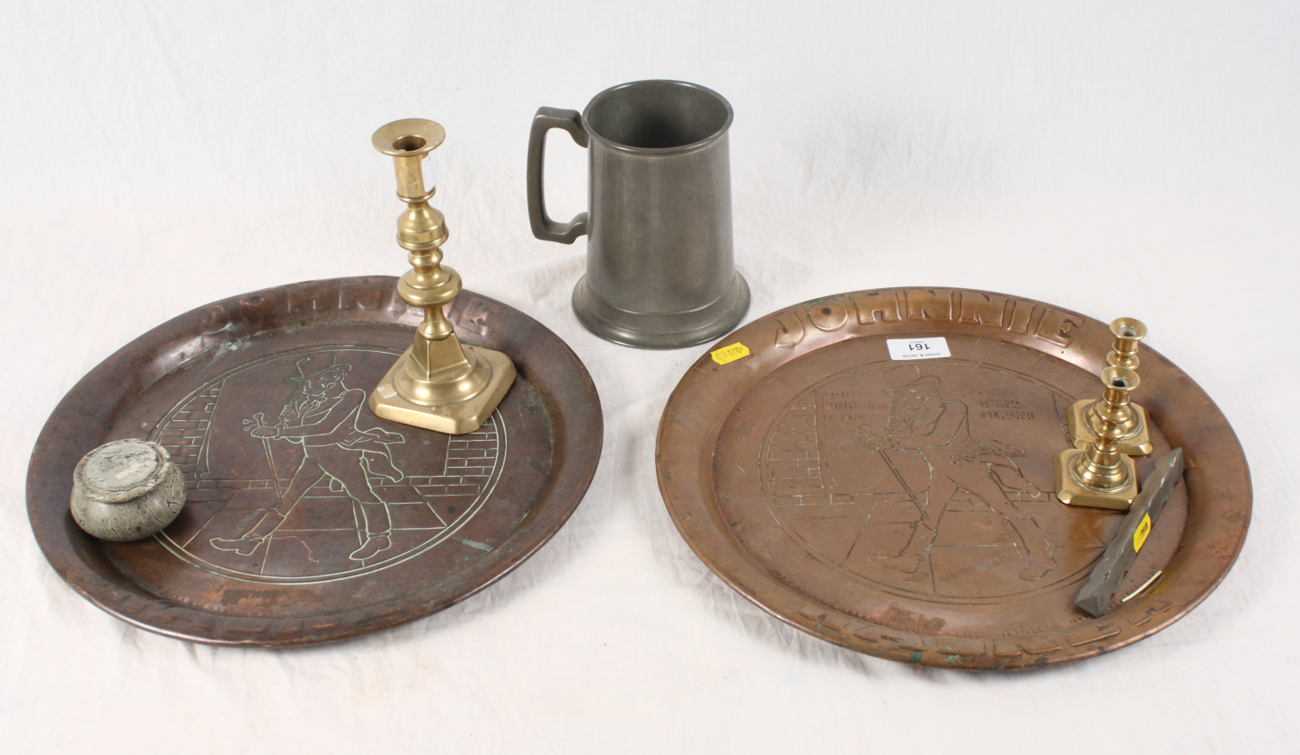 Two Johnny Walker embossed copper trays, a pewter tankard, three brass candlesticks and a serpentine