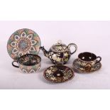 A Thoune teapot, two cups and saucers and a plate