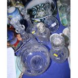 Four glass decanters and a pedestal glass fruit bowl