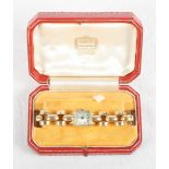 A lady's 18ct gold cased bracelet watch and a tooled and gilt red Morocco leather Cartier watch box