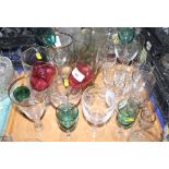 An assortment of drinking glasses including two with ruby bowls and three with green glass bowls