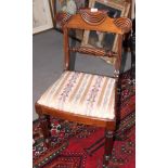 A set of four Regency mahogany dining chairs with rope twist carved back rails and Trafalgar