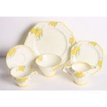 A 1930s Paragon Art Deco yellow flower and catkin decorated trio, matching milk jug, sugar and