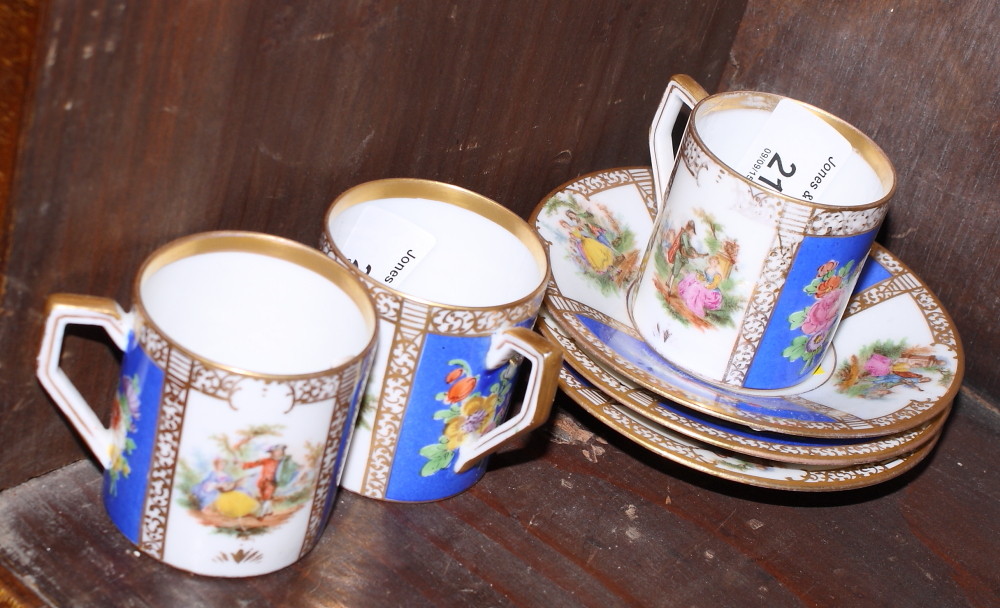 A set of three Bavarian porcelain "Dresden" pattern coffee cans and saucers