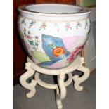 An oriental porcelain fish bowl, exterior decorated flowers, on cream painted wooden stand, 17" dia