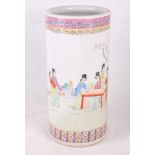 An oriental cylindrical porcelain stick stand decorated ladies in a garden, 18" high