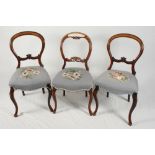 A set of four Victorian walnut balloon back dining chairs with floral tapestry seats and a pair of