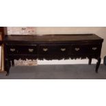 An 18th Century oak dresser base, fitted three deep frieze drawers, with shaped apron