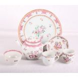 An early 19th Century famille rose porcelain plate, a similar teapot, a tea bowl and stand and two