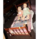 A doll with composition body, another doll with stuffed body and a doll's bed with patchwork cover