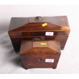 An early 19th Century mahogany sarcophagus-shaped two-compartment tea caddy with central mixing bowl