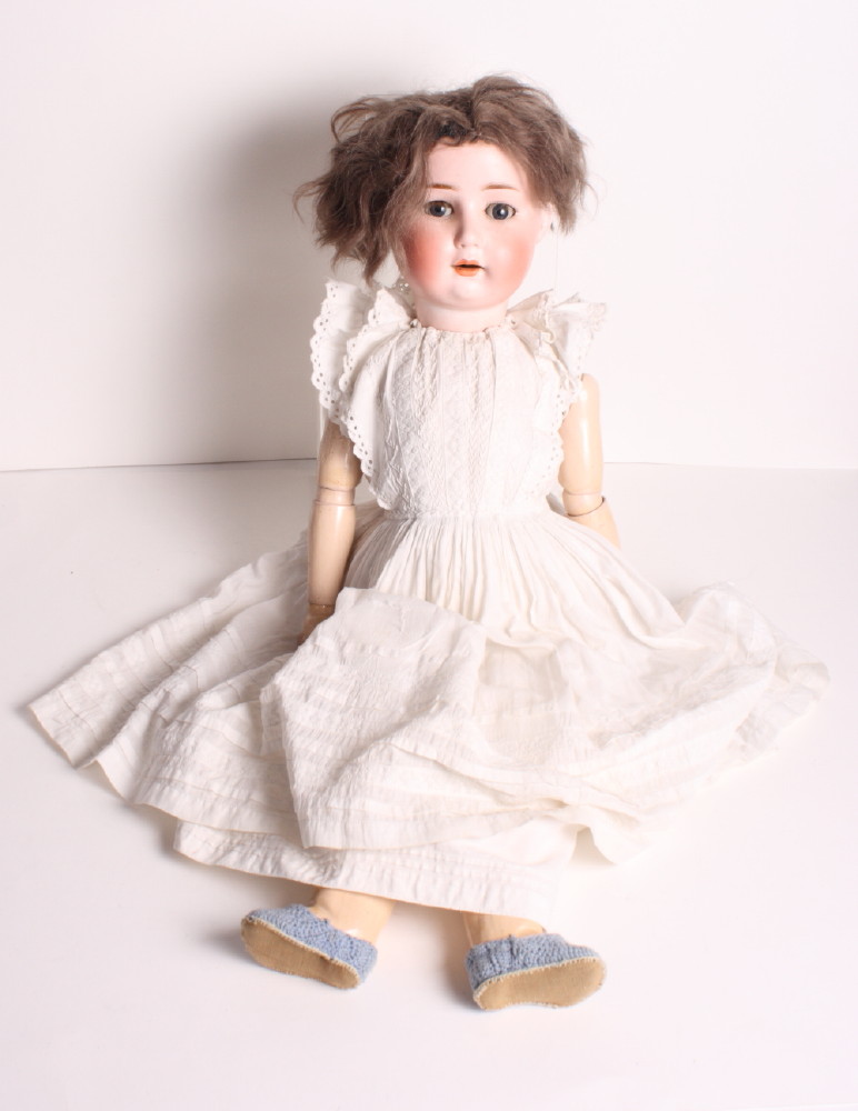 An early 20th Century Goebels porcelain headed doll with sleeping eyes and jointed composition body,