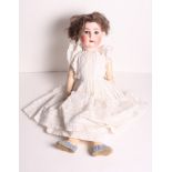 An early 20th Century Goebels porcelain headed doll with sleeping eyes and jointed composition body,