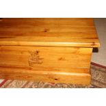 A waxed pine toy box with applied bear carving