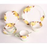 A 1930s Paragon Art Deco flower and brown leaf decorated trio, matching milk jug, sugar and cake