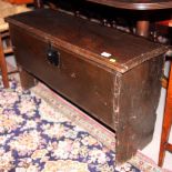 A 17th Century oak plank chest with hinged lid and iron lock, 40" long