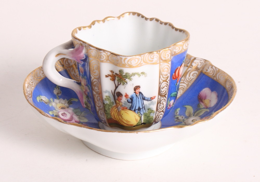 A Helena Wolfson figure decorated cabinet cup and saucer