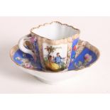 A Helena Wolfson figure decorated cabinet cup and saucer