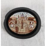 A 19th Century oval micro mosaic panel decorated view of St Peter's Square with black border and pin